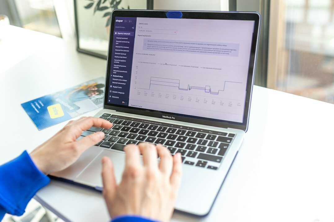 person checking finances on laptop
